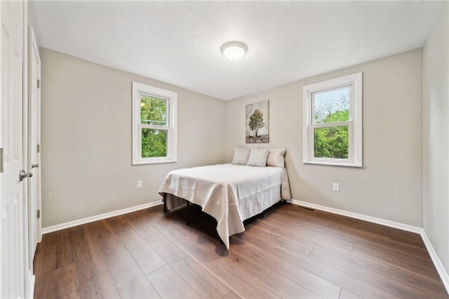 bedroom with multiple windows and baseboards