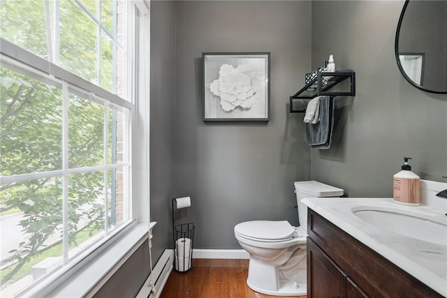 113 Lewisham Rd, Cranberry Twp, PA 16066 - half bathroom with wood finished floors, toilet, baseboard heating, baseboards, and vanity