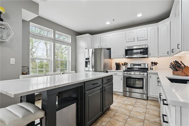 113 Lewisham Rd, Cranberry Twp, PA 16066 - kitchen with stainless steel appliances, white cabinetry, backsplash, light tile patterned floors, and recessed lighting