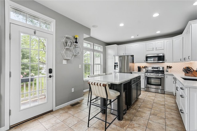 113 Lewisham Rd, Cranberry Twp, PA 16066 - kitchen with stainless steel appliances, tasteful backsplash, white cabinets, a kitchen bar, and recessed lighting