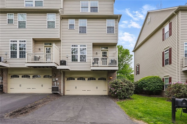 113 Lewisham Rd, Cranberry Twp, PA 16066 - view of front facade featuring a garage, driveway, brick siding, and cooling unit