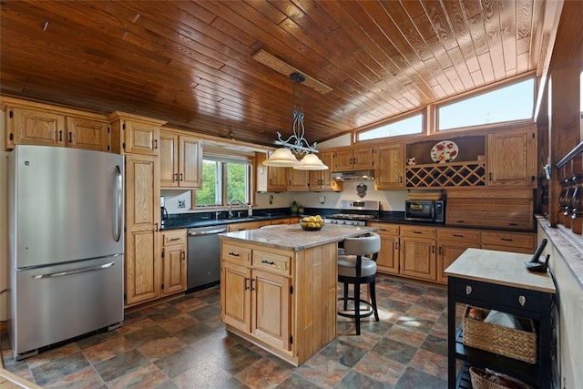 kitchen featuring stainless steel appliances, wooden ceiling, a sink, a center island, and stone finish flooring