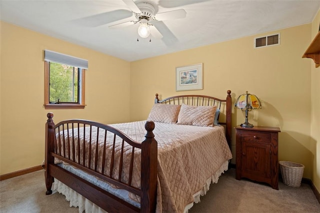 bedroom featuring light carpet, baseboards, and ceiling fan
