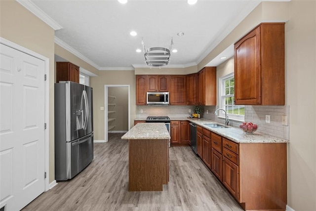 939 White Water Dr, Adams Twp, PA 16046 - kitchen with stainless steel appliances, a sink, a center island, light stone countertops, and light wood-type flooring