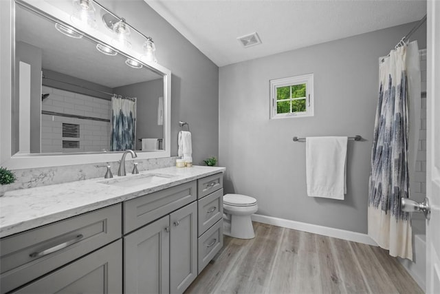 939 White Water Dr, Adams Twp, PA 16046 - bathroom featuring toilet, vanity, wood finished floors, a shower with shower curtain, and baseboards