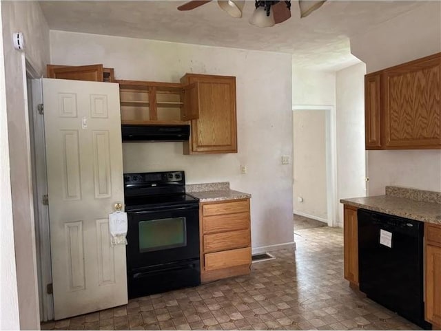 kitchen with black appliances, under cabinet range hood, ceiling fan, brown cabinetry, and light stone counters