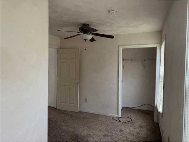 unfurnished bedroom with carpet flooring, a closet, and a ceiling fan