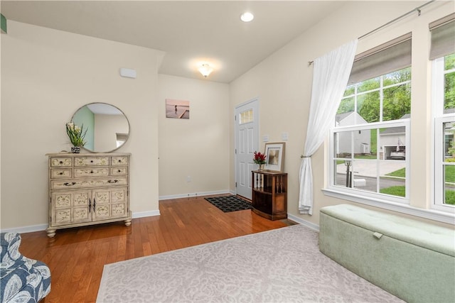 foyer featuring wood finished floors, baseboards, and recessed lighting