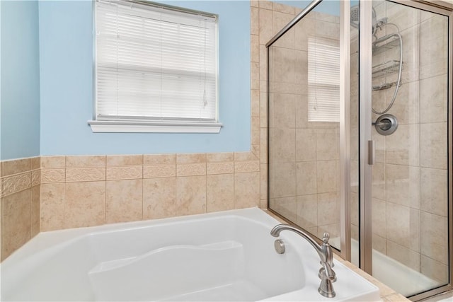 bathroom with a shower stall and a garden tub
