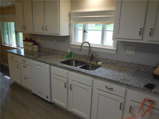 kitchen featuring dishwasher, a sink, white cabinetry, and wood finished floors