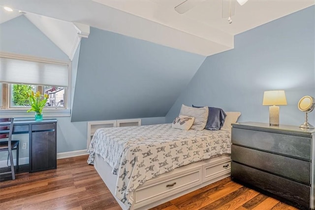 bedroom with lofted ceiling, wood finished floors, baseboards, and a ceiling fan