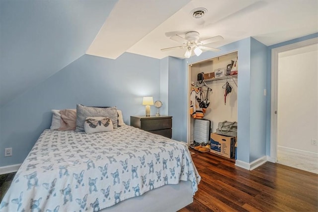 bedroom with wood finished floors, baseboards, a closet, and ceiling fan