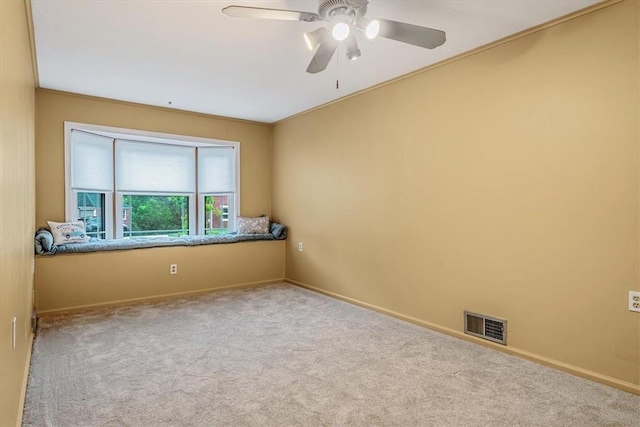unfurnished room featuring carpet floors, a ceiling fan, and baseboards