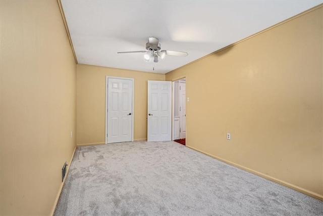 unfurnished bedroom with carpet floors, baseboards, and ceiling fan