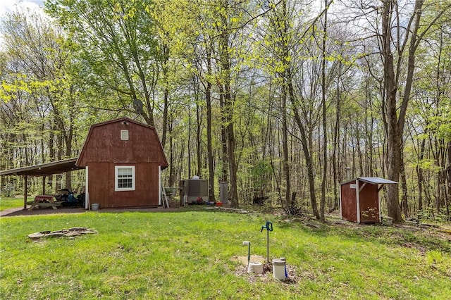 474 Barkley, Addison Twp, PA 15411 - view of grassy yard with a shed, an outdoor structure, a carport, and a wooded view