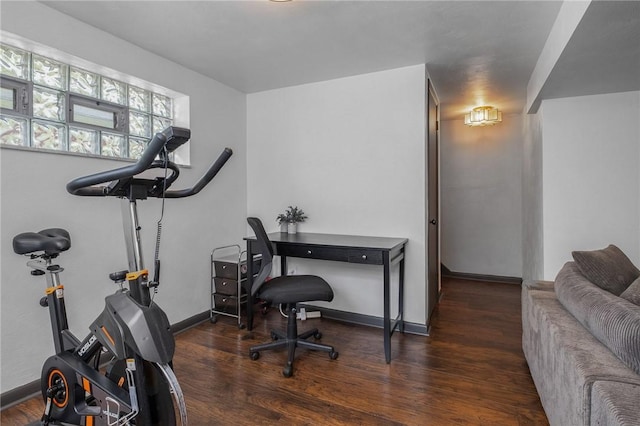 exercise room with wood finished floors and baseboards