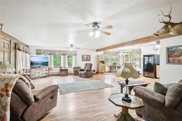 1770 Perry Hwy, Muddy Creek Twp, PA 16051 - living room featuring a textured ceiling, a ceiling fan, light wood-style floors, a baseboard radiator, and beamed ceiling