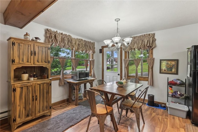 1770 Perry Hwy, Muddy Creek Twp, PA 16051 - dining room with a chandelier, plenty of natural light, light wood finished floors, and baseboards