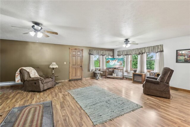 1770 Perry Hwy, Muddy Creek Twp, PA 16051 - living area with ceiling fan, wood finished floors, baseboards, and a baseboard radiator