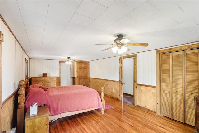 1770 Perry Hwy, Muddy Creek Twp, PA 16051 - bedroom with wood finished floors, wood walls, and ceiling fan
