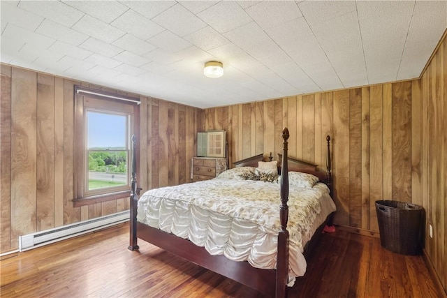 1770 Perry Hwy, Muddy Creek Twp, PA 16051 - bedroom with a baseboard heating unit, wood-type flooring, and wooden walls