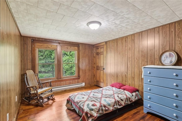 1770 Perry Hwy, Muddy Creek Twp, PA 16051 - bedroom featuring baseboard heating, wooden walls, and wood finished floors