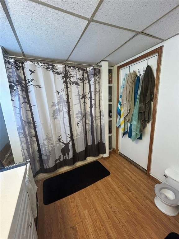 515 Green St, Saltsburg Area, PA 15681 - bathroom featuring wood finished floors, a paneled ceiling, a shower with shower curtain, and toilet