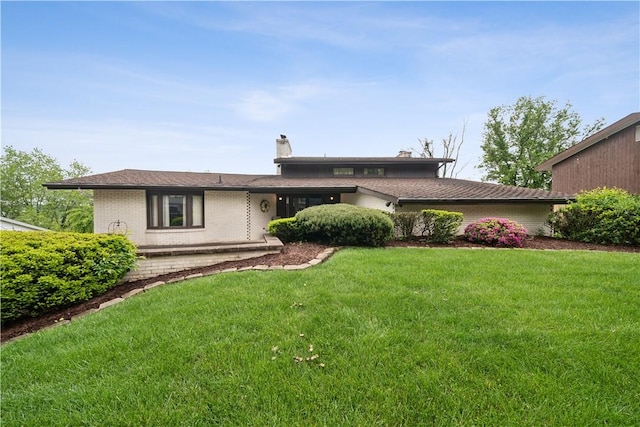 257 Penhurst Dr, Wilkins Twp, PA 15235 - view of front of house featuring a front lawn, brick siding, and a chimney
