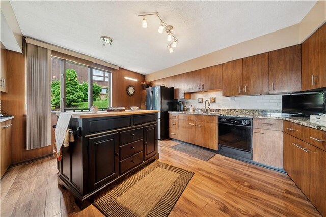 257 Penhurst Dr, Wilkins Twp, PA 15235 - kitchen with dishwasher, freestanding refrigerator, light wood finished floors, and decorative backsplash