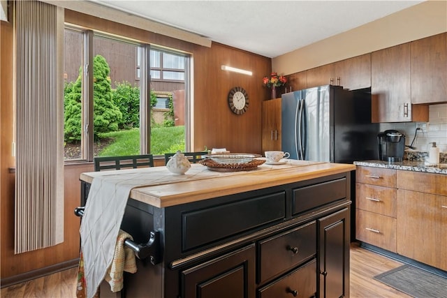 257 Penhurst Dr, Wilkins Twp, PA 15235 - kitchen with freestanding refrigerator, backsplash, light wood-type flooring, and wood walls