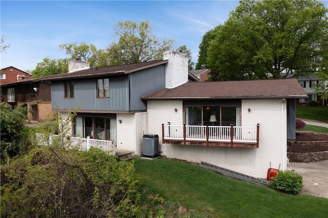 257 Penhurst Dr, Wilkins Twp, PA 15235 - rear view of property with a chimney, brick siding, central AC unit, and a lawn