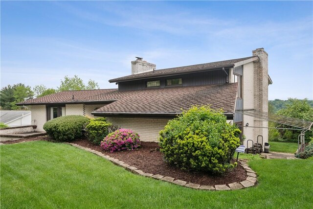 257 Penhurst Dr, Wilkins Twp, PA 15235 - back of house with a chimney and a yard