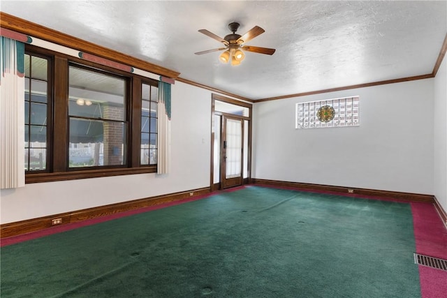 carpeted spare room with ornamental molding, ceiling fan, and baseboards