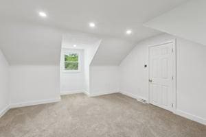 bonus room with vaulted ceiling, carpet flooring, baseboards, and recessed lighting