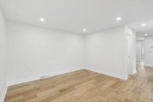 basement with wood finished floors, baseboards, and recessed lighting