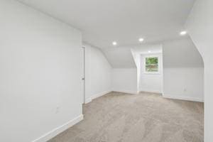 bonus room featuring baseboards, recessed lighting, vaulted ceiling, and carpet flooring