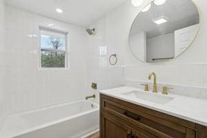 bathroom featuring vanity and washtub / shower combination