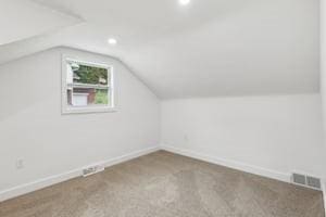 additional living space with vaulted ceiling, baseboards, recessed lighting, and carpet