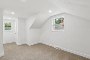 bonus room with carpet floors, plenty of natural light, recessed lighting, lofted ceiling, and baseboards
