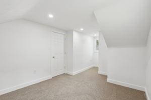 additional living space featuring lofted ceiling, baseboards, recessed lighting, and carpet floors