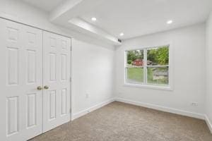 unfurnished bedroom featuring baseboards, recessed lighting, a closet, and carpet flooring