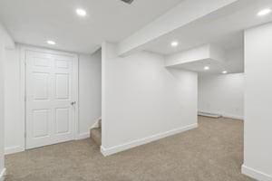 finished below grade area with recessed lighting, baseboards, stairway, and carpet