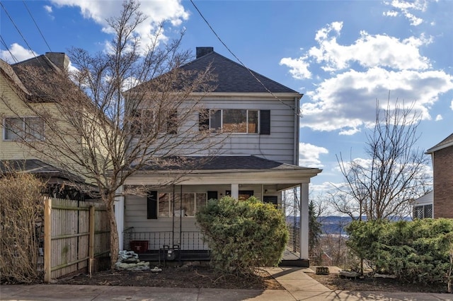 2252 Milligan Ave, Swissvale, PA 15218 - view of front of home with covered porch, fence, a shingled roof, and a chimney