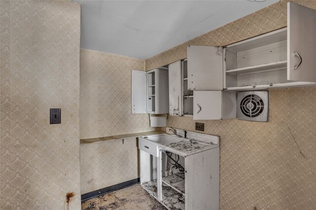 2252 Milligan Ave, Swissvale, PA 15218 - kitchen with open shelves, light countertops, and unfinished concrete flooring