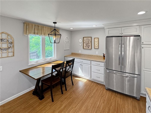 550 Brushglen Ln, Pleasant Hills, PA 15236 - kitchen with freestanding refrigerator, light wood finished floors, light countertops, white cabinetry, and recessed lighting