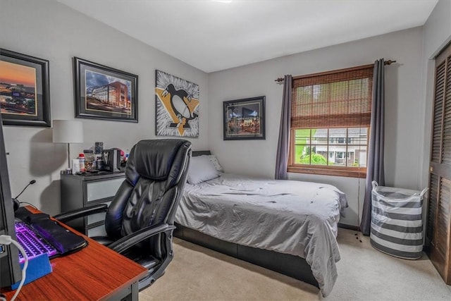 carpeted bedroom featuring an office area