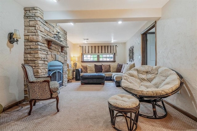 living area featuring carpet, a fireplace, baseboards, and a textured wall