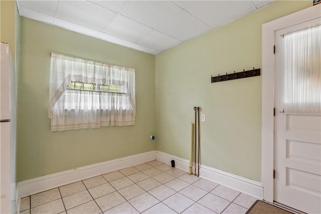 clothes washing area featuring tile patterned flooring and baseboards