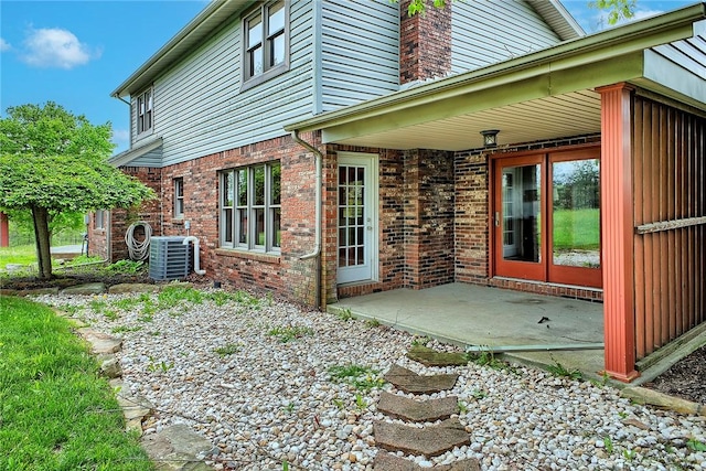 5569 Camerons Rd, Brush Val/Buffington, PA 15748 - rear view of house with cooling unit, a patio, and brick siding