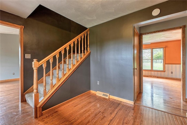 5569 Camerons Rd, Brush Val/Buffington, PA 15748 - stairway featuring wood-type flooring, baseboards, and a wainscoted wall
